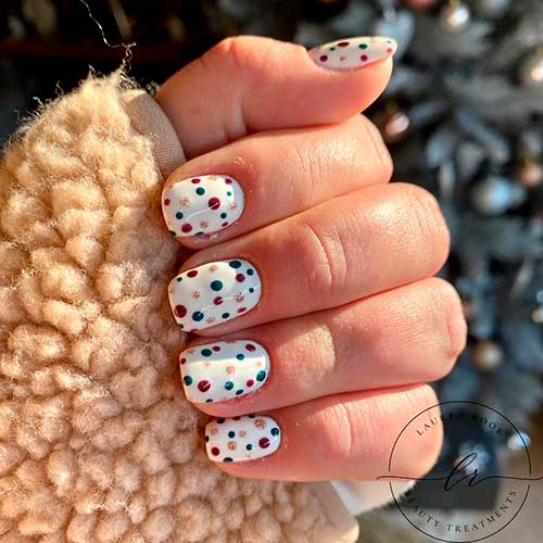 Cute multi coloured polka dot nail art over white base short nails for stunning look!