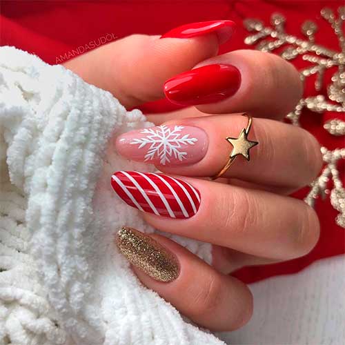 Cute red Christmas nails 2020 almond shaped with three accent white snowflake, candy cane, and gold glitter nails!