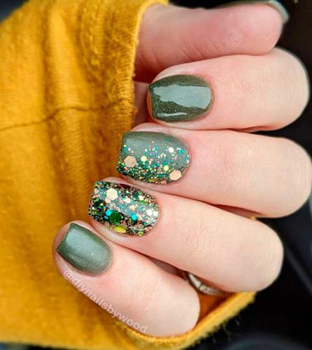 Cute short shimmer olive green nails design with two accent glitter nails for having attractive look!