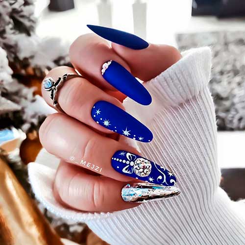 Gorgeous long almond matte royal blue Christmas nails 2020 with accent silver nail and rhinestones.