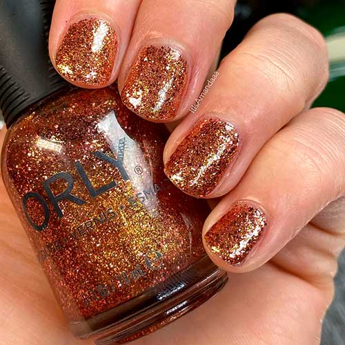 Inexhaustible Charm is a rose gold glitter Orly nail polish applied on short nails to celebrate Holiday 2020