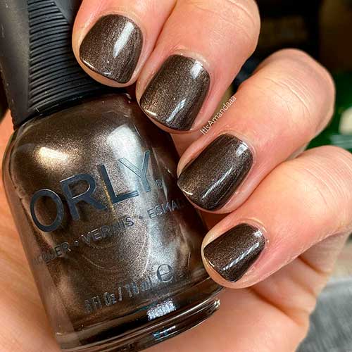Infinite Allure is a charcoal shimmer Orly nail polish applied on short nails to celebrate Holiday 2020
