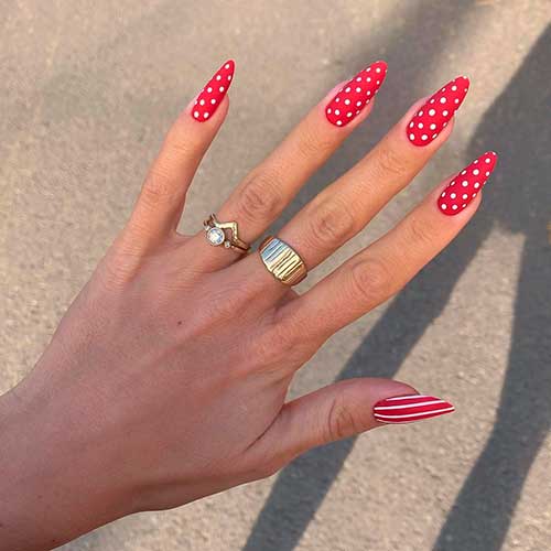 Cute almond shaped bright red white polka dot nails 2020 design with accent red white stripe nail design!