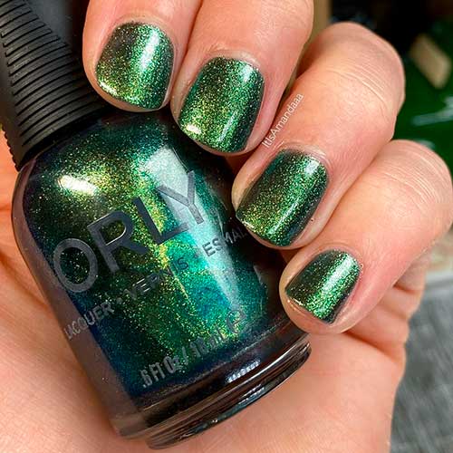 Nouveau Riche is a golden emerald shimmer orly nail polish applied on short nails to celebrate Holiday 2020