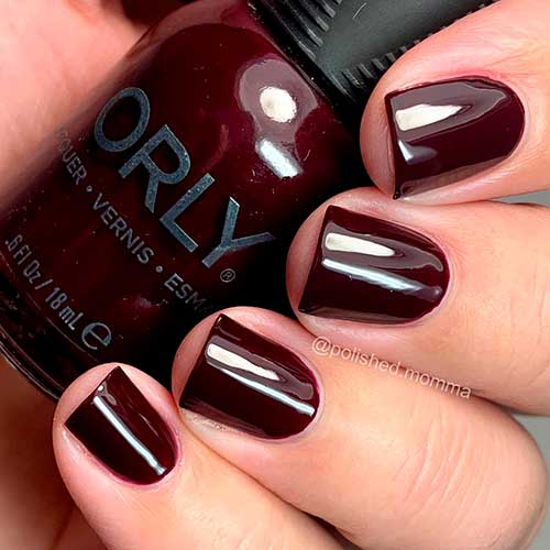 Opulent Obsession is a deep cherry créme Orly nail polish applied on short nails to celebrate Holiday 2020