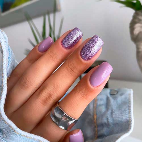 Square shaped light purple nails with purple glitter over two accent nails!