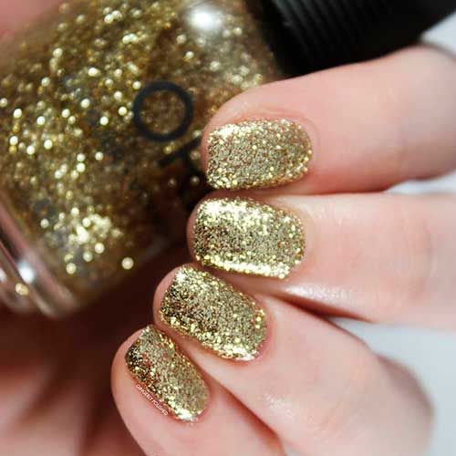 Untouchable Decadence is a gold glitter Orly nail polish applied on short nails to celebrate Holiday 2020