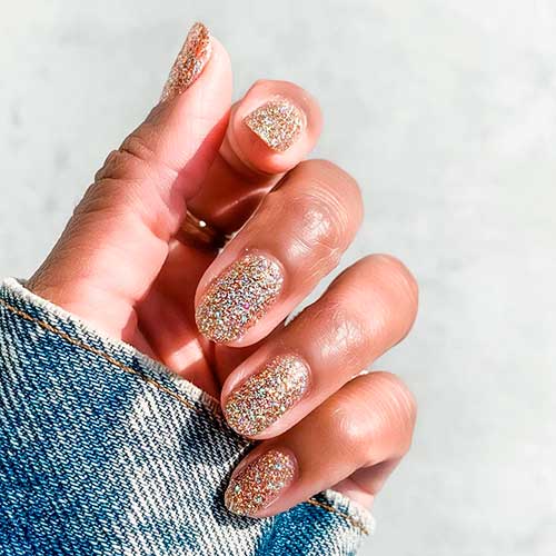 Amazing gold glittery short nails done with OBVI Gold Glitter Nail Polish by olive & June!