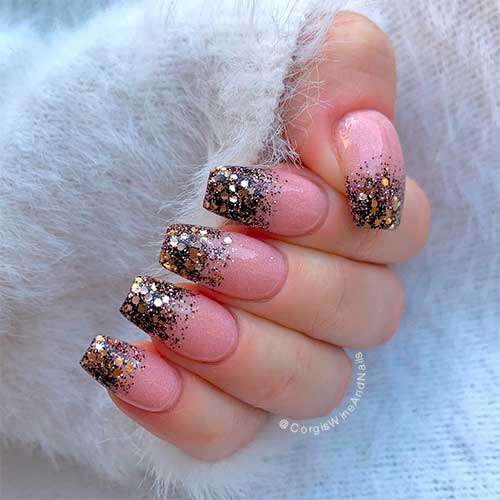 Coffin shaped nude colored with black and gold glitter nails for new years 2021!
