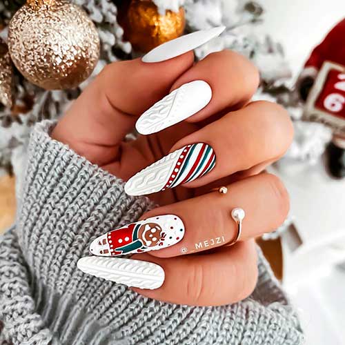 Cute almond shaped white Christmas nails 2020 design consists of sweater nails, and accent snowman nails!