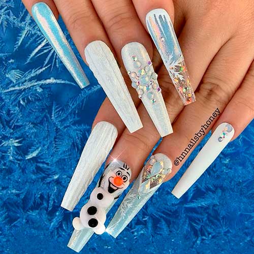Cute long coffin shaped Christmas nails 2020 design consist of sweater nails, snowflake nails, and accent snowman nail!