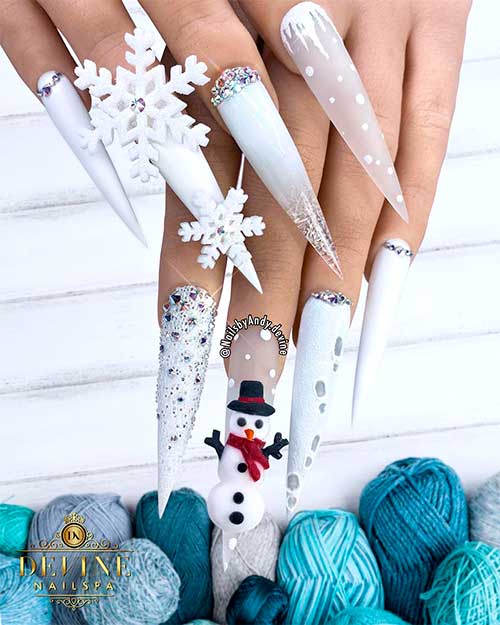 Elegant White stiletto Christmas nails adorned with rhinestones, 3d snowflakes, and accent snowman nails!