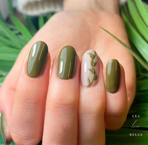 Glossy Olive Green with Leaf Nail Art Short Round Shaped Glossy Olive Green with An Accent Nude Nail Adorned with Leaf Nail Art