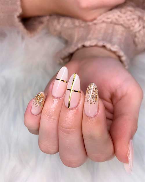 Gorgeous almond shaped nude nails 2021 with gold glitter and strips design for new year! Gorgeous almond shaped nude nails 2021 with gold glitter and strips design for new year!