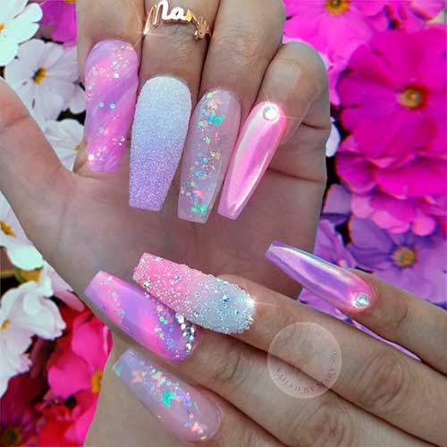 Cute pink and purple unicorn nails idea the uses butterfly glitter, rhinestones, confetti glitter and chrome unicorn powder!