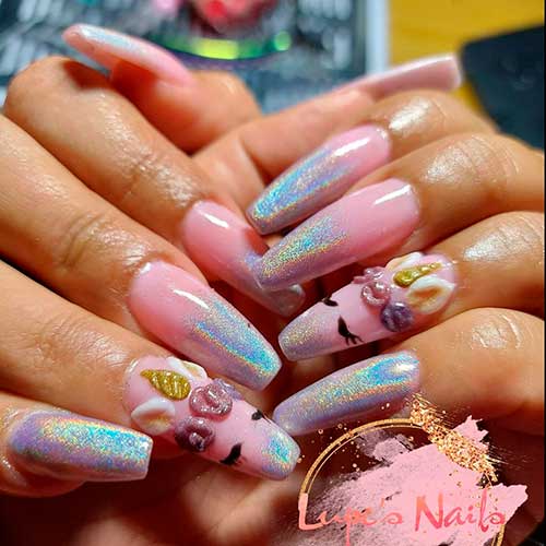 Unicorn holographic nails tips over pink base color are stunning with prominent acrylic unicorn face
