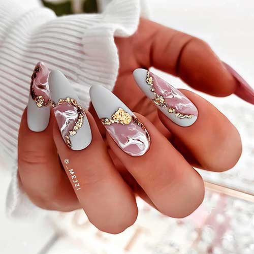 Almond shaped white marble nails 2021 with decorative gold foil flakes design!