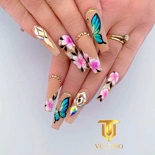 Cute matte nude coffin nails blended with butterfly nails, floral nails, with gold glitter and rhinestones. Cute matte nude coffin nails blended with butterfly nails, floral nails, with gold glitter and rhinestones.