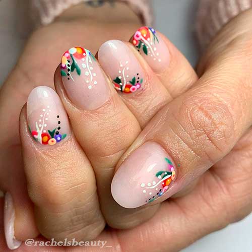 Cute short nails with floral nail art at nail tips and bases for spring 2021!