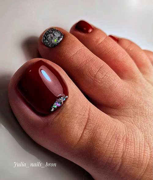 Dark maroon toenails with silver glitter accent toenail and some rhinestones!