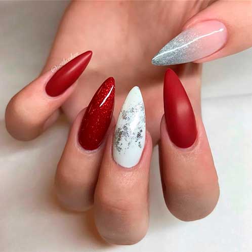 Almond shaped matte red nails with glossy red nails and two accent white and French ombre nail with glitter! 