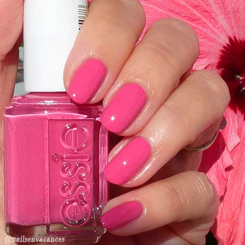 Cute bright pink short round nails achieved with Essie bright pink nail polish Slumber Party On!