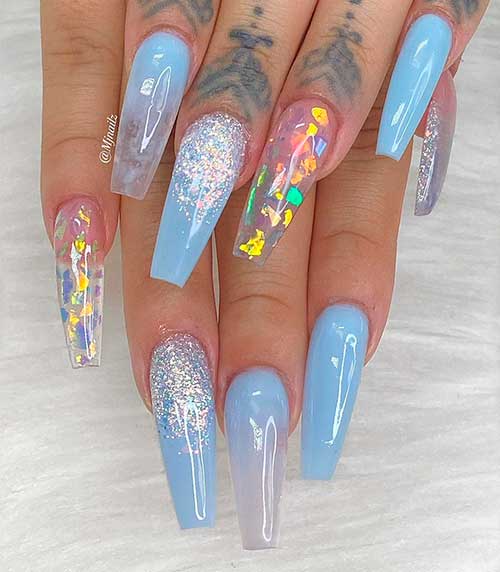Cute coffin shaped light blue nails with silver glitter and encapsulated confetti glitter on accent clear nail!