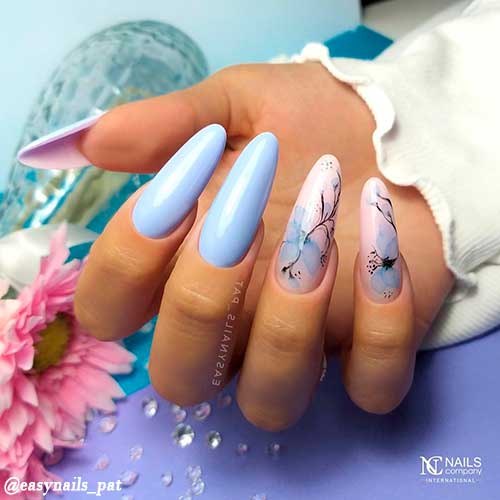 Cute light blue nails with two accent light pink nails with light blue touches and black lines!