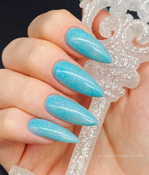 Cute light blue stiletto nails with micro glitter for a sparkling look!