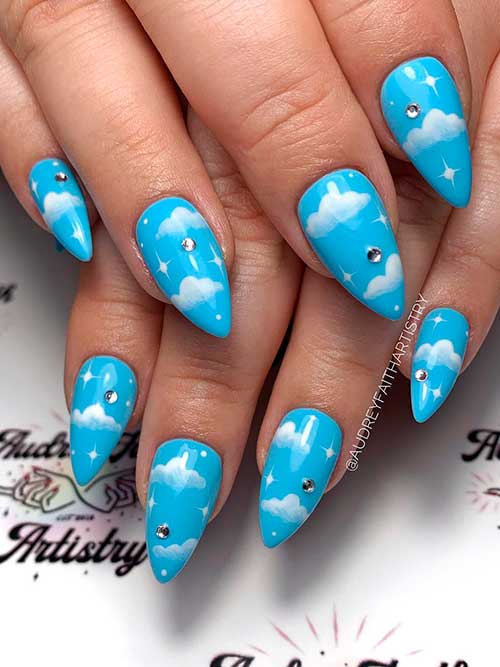 Light Blue Nails with Cloud Nail Art Medium Stiletto Light Blue Nails with White Cloud Nail Art and Silver Rhinestones