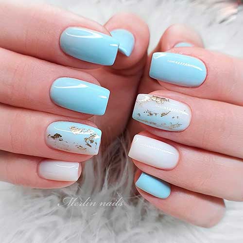 Light blue short square nails with gold touches on the accent nail and other nude color accent nail!