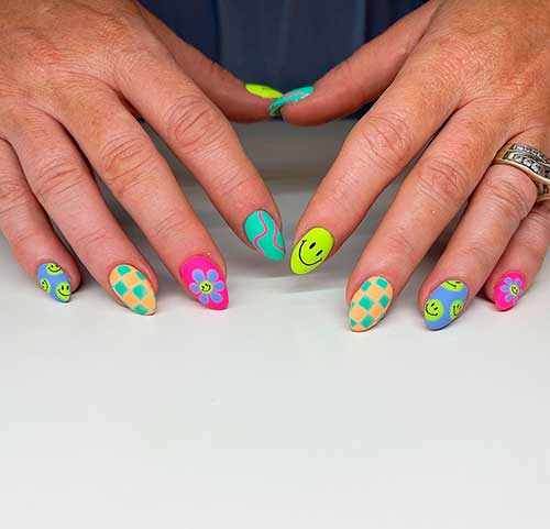 Short almond shaped colorful smiley face nails 2022 with checkered, flower, and swirl accents Short almond shaped colorful smiley face nails 2022 with checkered, flower, and swirl accents