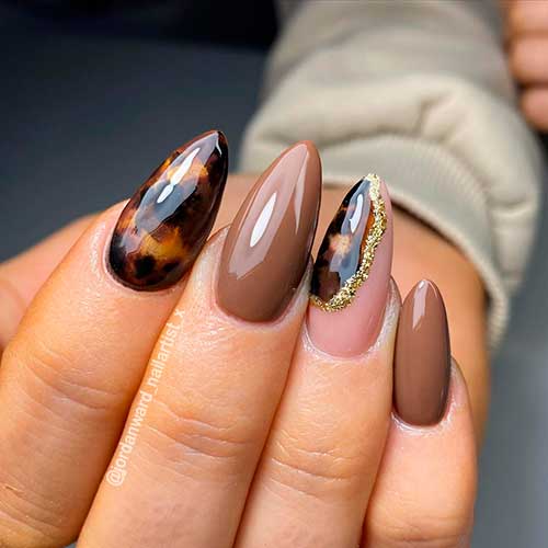 Glossy Almond Shaped Caramel and Tortoise nails with gold glitter