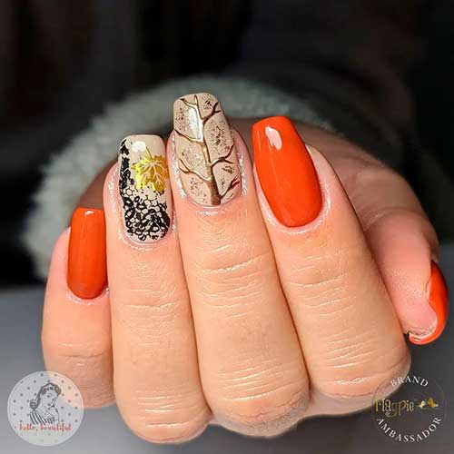 Short burnt orange coffin fall nails with a golden leaf and leafless fall tree on accents