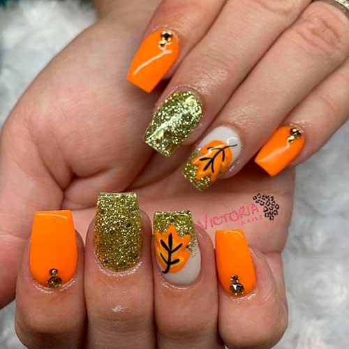 Vibrant and Glittery Autumn Orange Nails square-shaped with fall leaf, best fall nails 2021