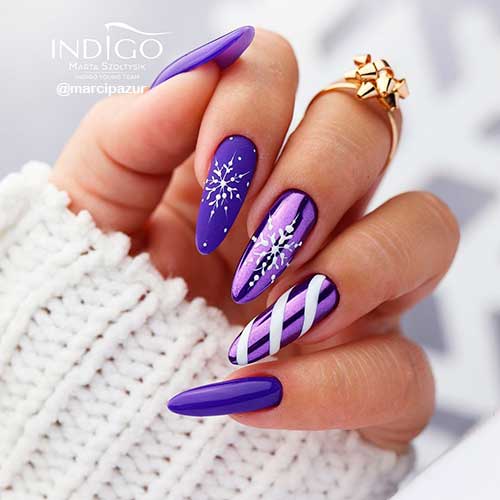 Glossy, Matte, and Chrome Purple Christmas Nail Art Glossy, Matte, and Chrome Purple Christmas Nails with White Snowflakes and Candy cane Strikes