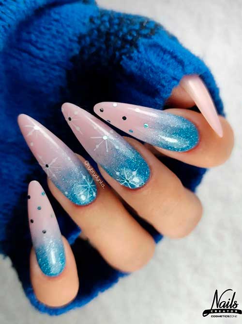 Long almond-shaped glitter blue ombre nails with snowflakes and glitter for the winter season