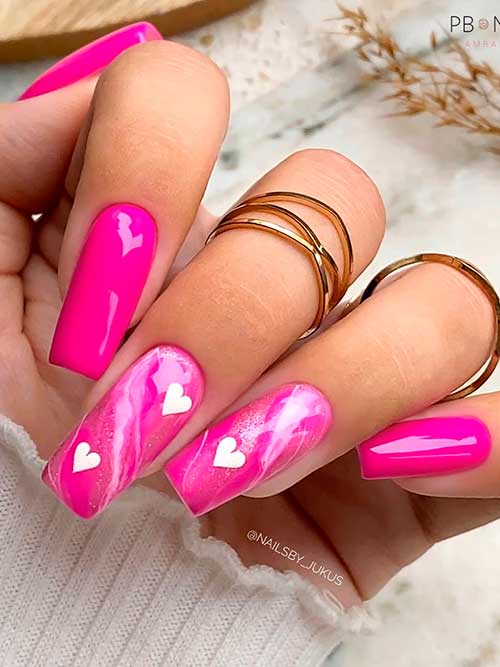 Long square hot pink valentines day nails 2022 with white hearts and marble effects on two accents