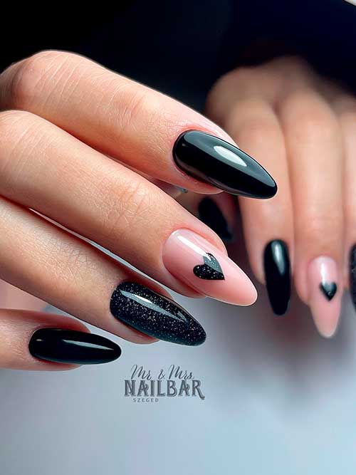 Long almond-shaped black valentine’s day nails 2023 with a heart shape on a nude accent nail