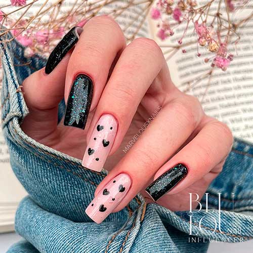 Long square-shaped glitter black valentine’s nails 2023 with black hearts on two nude accent nails