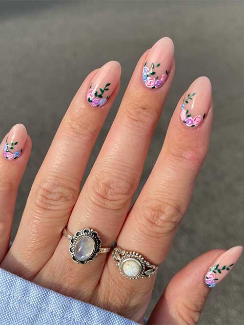 Medium almond-shaped nude nails 2023 with spring roses