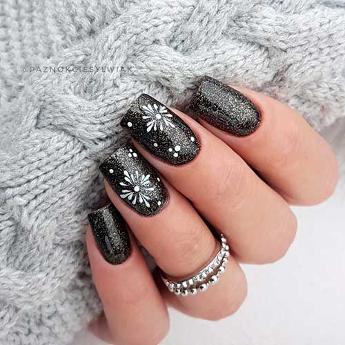 Medium square glitter black nails with white snowflakes and dots on two accents - Classy black nail designs 2022