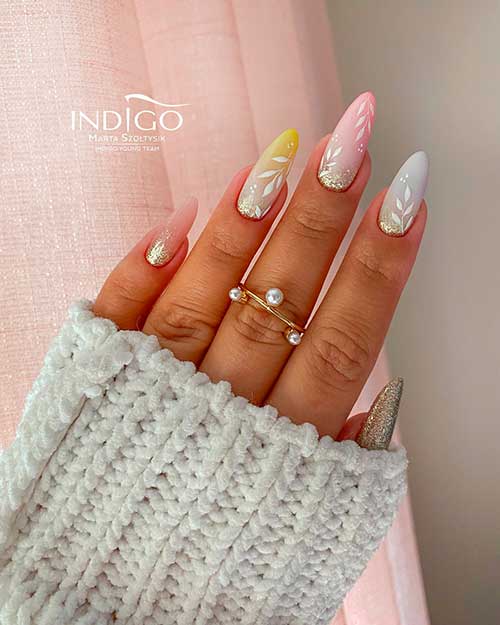 Long almond multicolor nails with glittery ombre nail art and leaf nail art that suits spring time