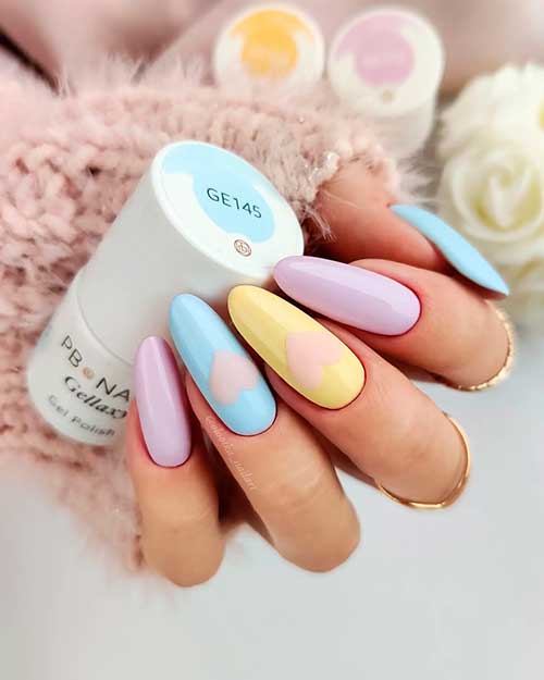 Long round pastel multicolor nails with pastel lilac, light yellow, baby blue spring nail colors