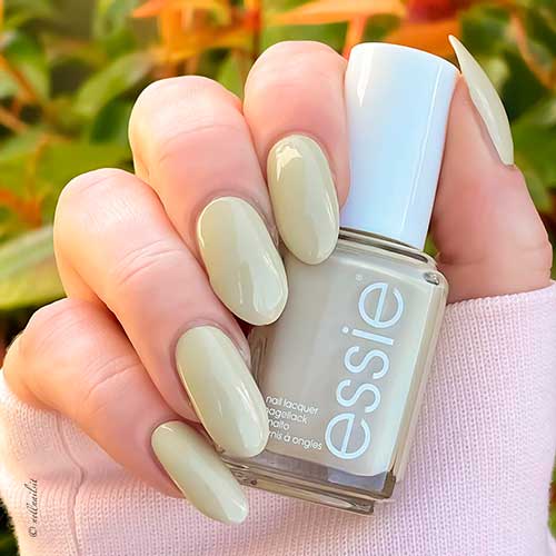 Long round pastel yellow nails with white undertones using sing songbird along Essie nail polish