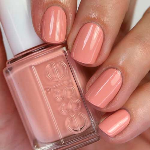 Short pastel coral nails that uses Essie Nail Polish spring awakening for spring 2022