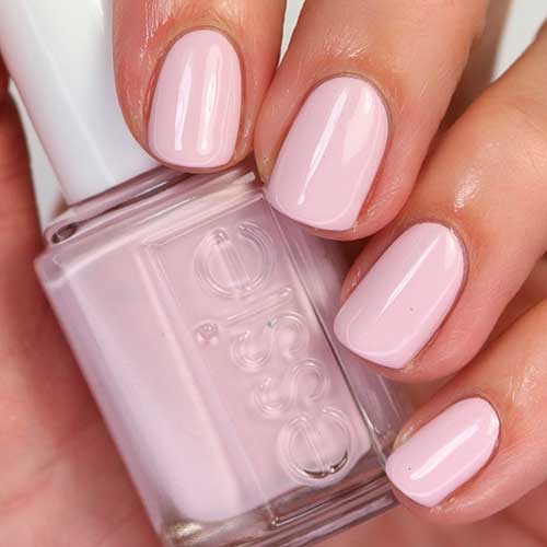 Short pastel pink nails that uses Stretch Your Wings Essie Nail Polish for spring 2022