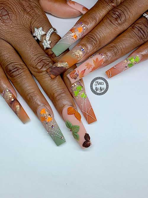 Long matte autumnal ombre nail colors with maple leaf nail art and rhinestones