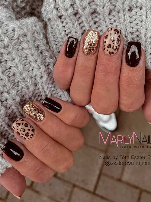 Short dark brown nails with leopard prints and gold glitter accents