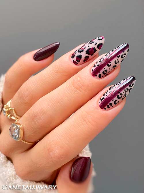 Long almond shaped burgundy fall nails with leopard prints